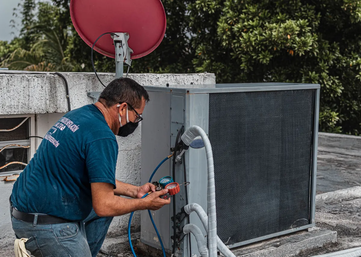 HVAC technician servicing an outdoor condenser unit